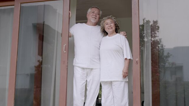 Asian Elderly man and woman stand and happy in home.