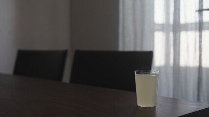 ginger beer in tumbler glass on walnut table indoor