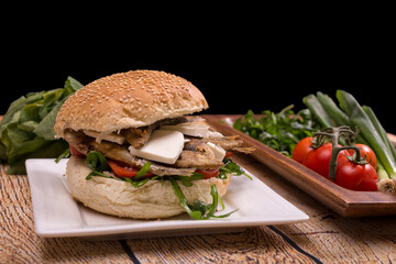 Burger with fried sardinas and feta cheese