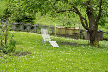 White empty deck chair at garden. Photo taken May 22nd, 2021, Zurich, Switzerland.