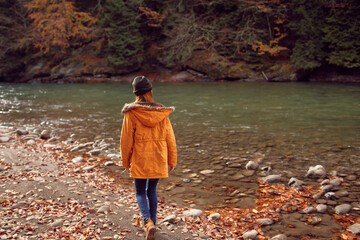 woman hiker near river mountains autumn travel