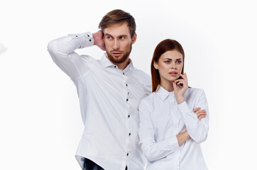 man and woman in white shirts are standing next to each other smile communication family