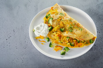 Omelette with cream sauce on plate