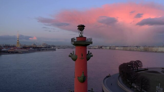 Top view on the rastral column, which is located in the city of Saint- Petersburg, on the street there are white nights, a beautiful sky and a calm Neva river.