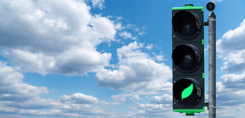 Traffic light with green leaf symbol. Clean mobility concept	