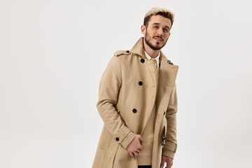 man beige coat hands on the belt look ahead fashionable hairstyle