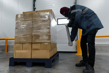 Staff wrapping film packaging boxes at cold storage warehouse, Loading goods prepare storage in the...