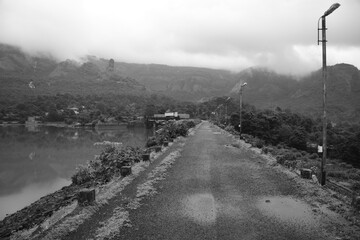 Black and white path to trek surrounded by mountains and lakes