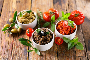 assorted of tapenade- black and green olive and tomato
