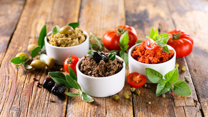 assorted of tapenade- black and green olive and tomato