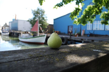 Pear in foreground fishing vessel in background 