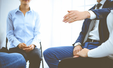 Obraz premium Group of people sitting in a circle during therapy. Meeting of business team participating in training