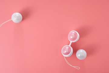 Ben Wa vaginal pleasure balls, Kegel balls on pink background, top view, soft light, empty space for text