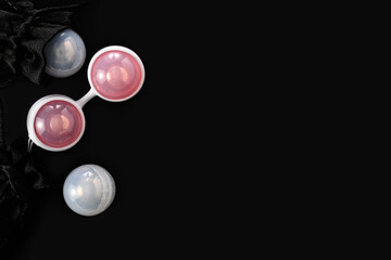 Ben Wa vaginal pleasure balls, Kegel balls on black background, top view, empty space for text