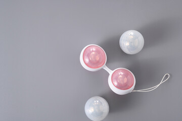 Ben Wa vaginal pleasure balls, Kegel balls on gray background, top view, soft light, empty space for text