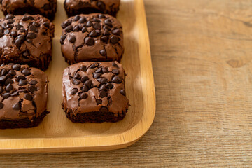 dark chocolate brownies topped by chocolate chips