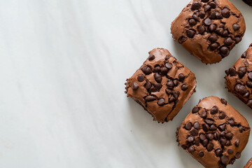 dark chocolate brownies topped by chocolate chips