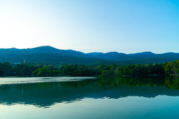 Ang Kaew lake at Chiang Mai University with forested mountain