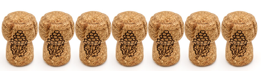 cork plugs from champagne bottles on white background