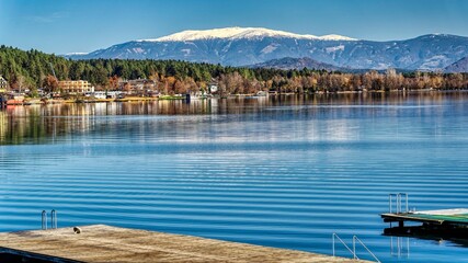 scenery at the lake with snow covered mountains in late autumn