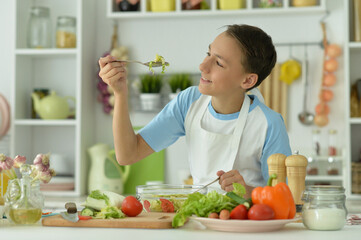 Obraz na płótnie Canvas Cute boy preparing cooking at home