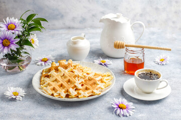 Homemade belgian waffles with honey.