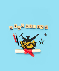 Graduation diploma, letters and pencils on blue background. Degree day, Education concept. Congrats...