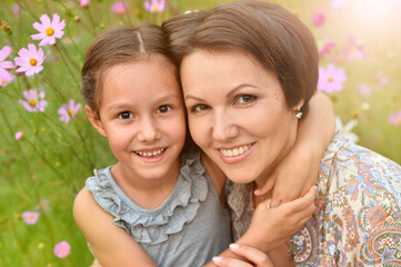 Portrait of  happy mother and daughter smiling  outdoors