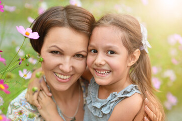 Portrait of  happy mother and daughter smiling  outdoors