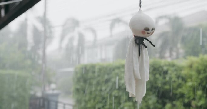 Cute traditional Japan Doll Teru teru bouzu hanging on a rainy day