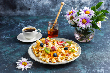 Homemade belgian waffles with honey.