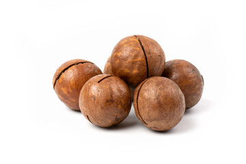 A pile of macadamia nuts in close - up isolated on a white background.