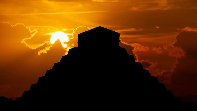 Ancient Maya Pyramid in Chichen Itza, Time Lapse at Sunset with Red Sun and Fiery Sky, Mexico