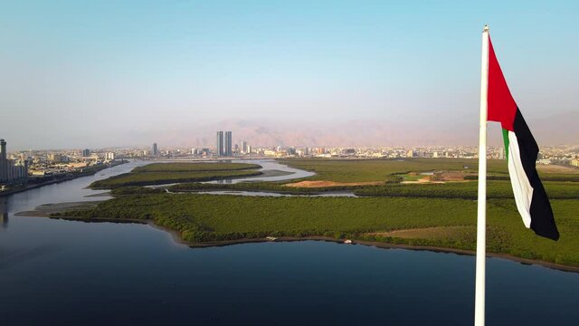 UAE flag and Ras al Khaimah emirate in the north United Arab Emirates aerial skyline landmark view