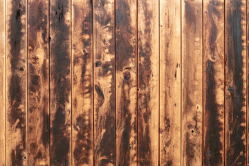 Fototapeta premium Texture of an old wooden wall with heavy signs of use as background image.