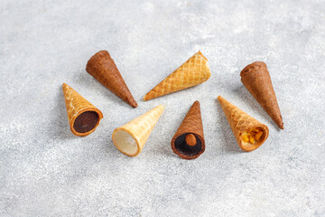 Mini waffle cones filled with chocolate and nuts.