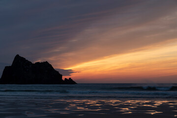 Absolutely stunning landscape images of Holywell Bay beach in Cornwall UK during golden hojur sunset in Spring