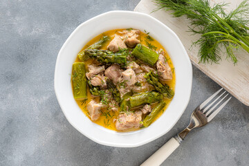 Turkey stew in gravy with asparagus and dill. Meat goulash