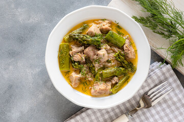 Turkey stew in gravy with asparagus and dill. Meat goulash