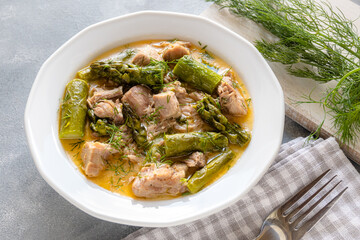 Turkey stew in gravy with asparagus and dill. Meat goulash