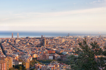 Obraz premium Sagrada Familia dominates the panorama of Barcelona from the top of the hill
