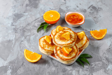 Homemade american pancakes with orange fruits.