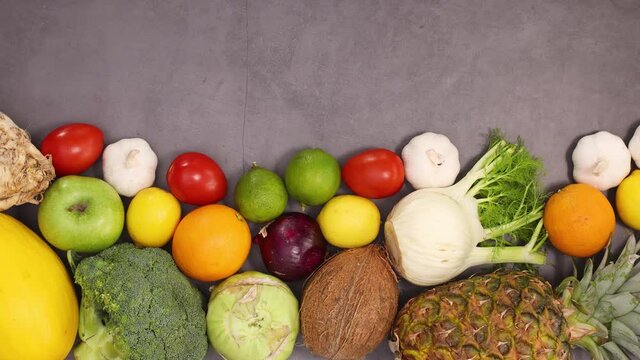 Organic healthy fruits and vegetables ordered on the bottom of kitchen table. Stop motion