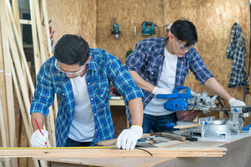 Craftsmans working together at carpentry shop. Worker or Professional constructor repair in wood...