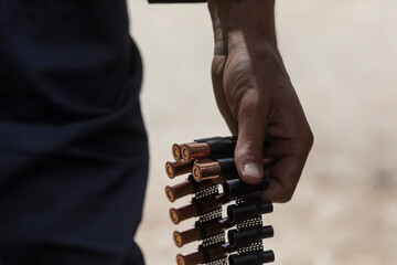 A man carries bullets for heavy machine guns - obrazy, fototapety, plakaty