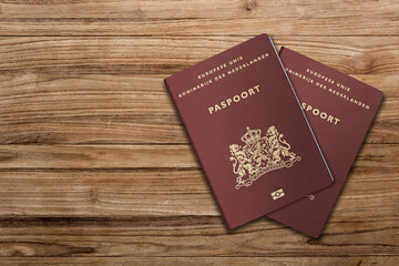 Netherlands passport on a wooden background, citizenship by investment, Dutch citizen
