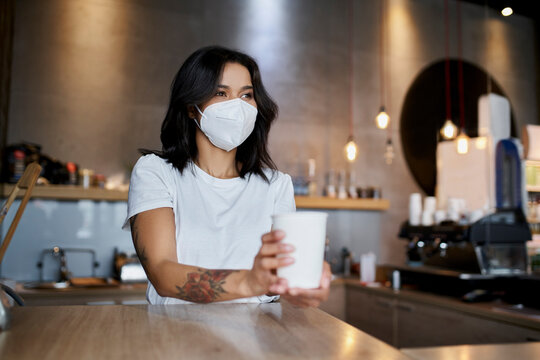 Female Barista With Mask Serving Coffee During Coronavirus Pandemic