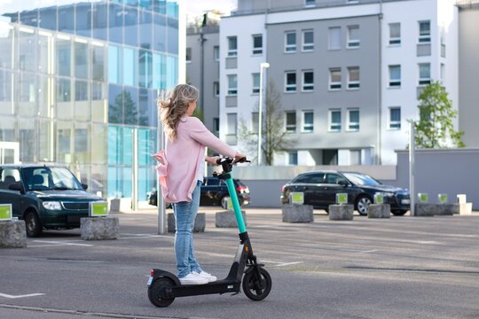 Business Woman Riding Electric Scooter