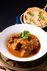 Food concept Homemade beef masala curry and roti paratha on wooden board with copy space