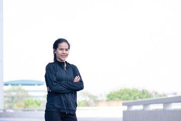 Young Asain woman fold over with sportwear smile emotion at outdoor running track. People happy...